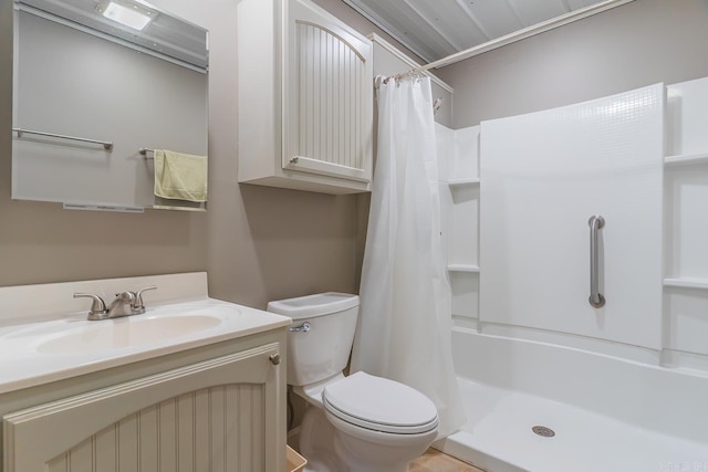 bathroom featuring curtained shower, toilet, and vanity