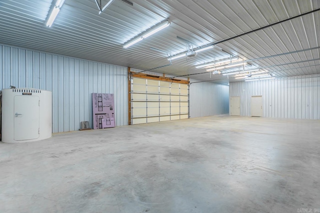 garage featuring a garage door opener and metal wall