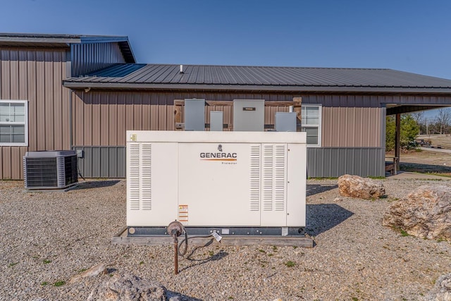 details featuring cooling unit, a power unit, and metal roof