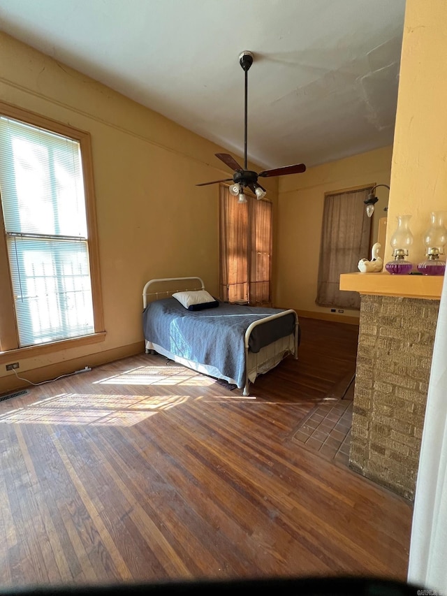 bedroom featuring visible vents and wood finished floors