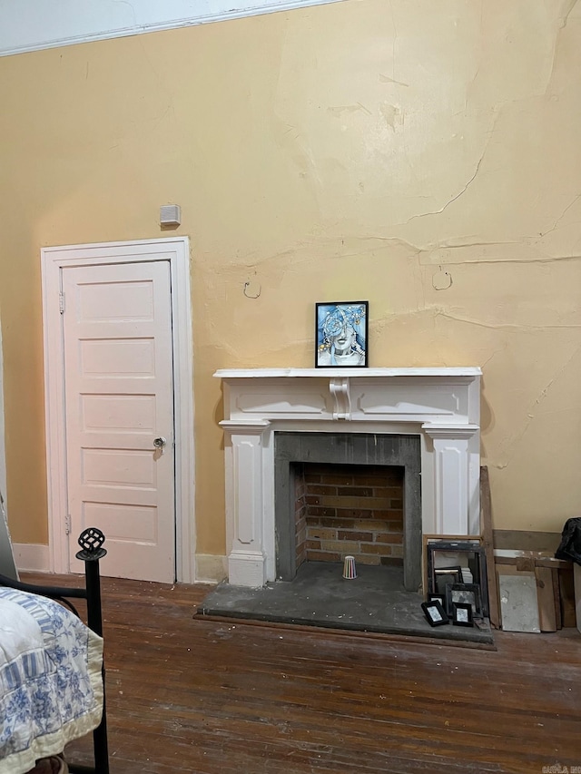 room details with a fireplace with flush hearth and wood finished floors