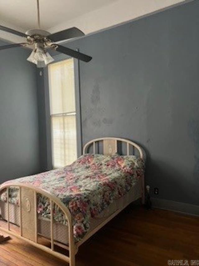 bedroom with baseboards, wood finished floors, and ceiling fan