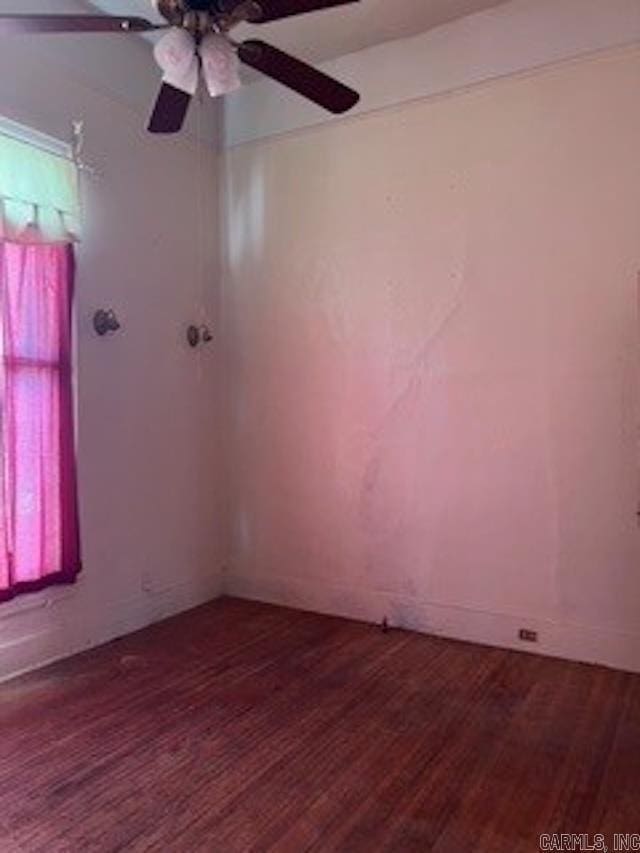 empty room with a ceiling fan and wood finished floors