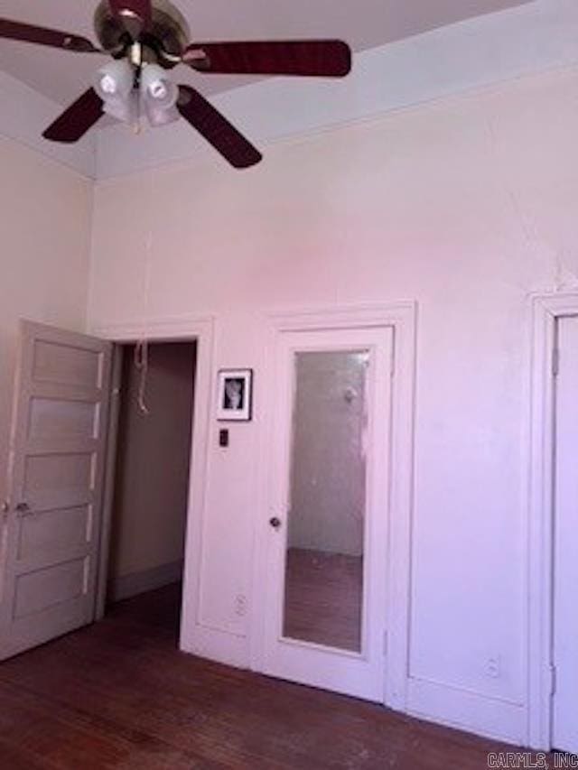 unfurnished bedroom featuring wood finished floors and a ceiling fan