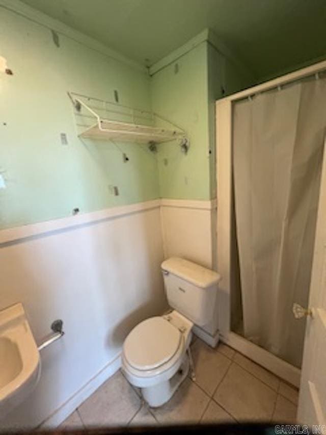 full bathroom featuring ornamental molding, toilet, tile patterned flooring, and curtained shower