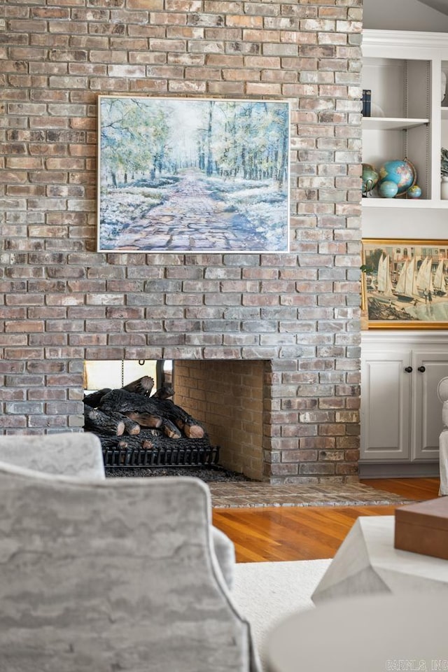 interior details featuring wood finished floors and a fireplace