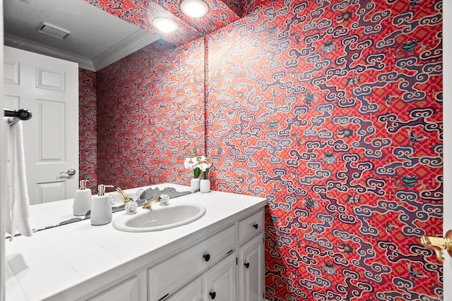 bathroom featuring visible vents, ornamental molding, and vanity