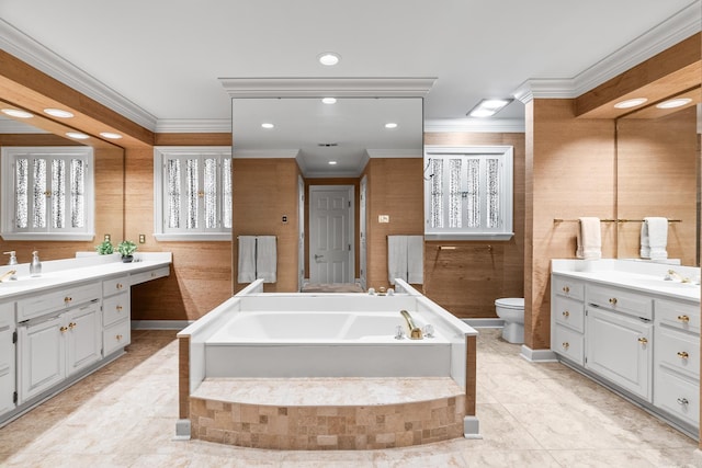 bathroom with a bath, two vanities, a sink, crown molding, and toilet