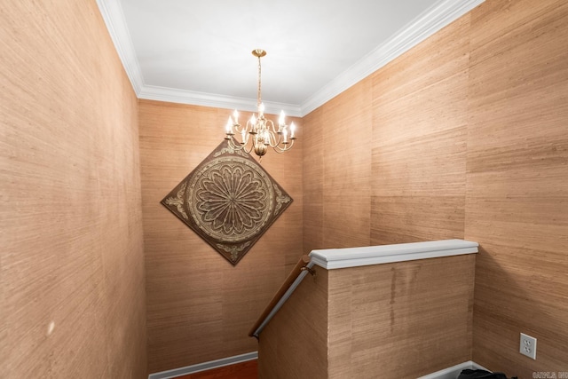 stairs with an inviting chandelier and ornamental molding