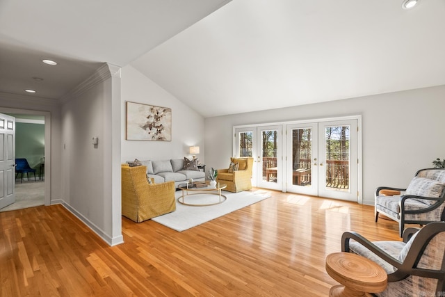 living room featuring french doors, baseboards, and wood finished floors