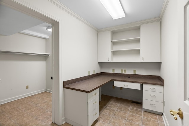 unfurnished office featuring light tile patterned floors, baseboards, crown molding, and built in study area