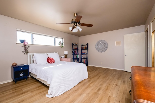 bedroom featuring ceiling fan, light wood-type flooring, and baseboards