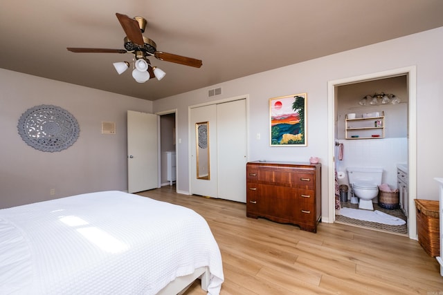 bedroom with visible vents, a closet, connected bathroom, light wood-style floors, and ceiling fan