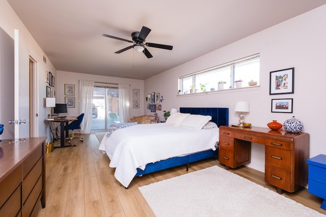 bedroom featuring access to exterior, multiple windows, a ceiling fan, and light wood finished floors