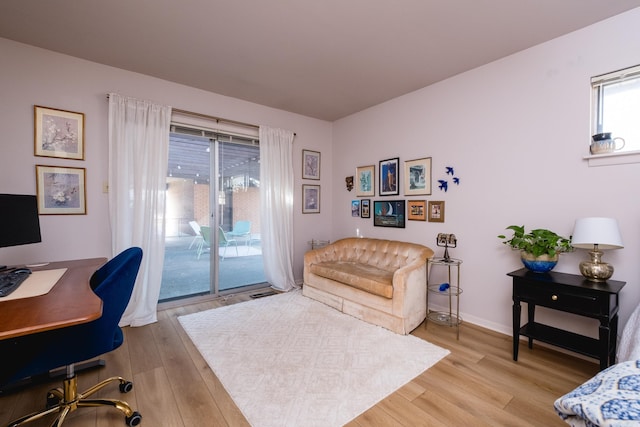 office space featuring light wood-type flooring and baseboards