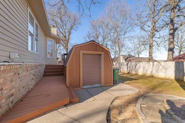 view of shed featuring fence