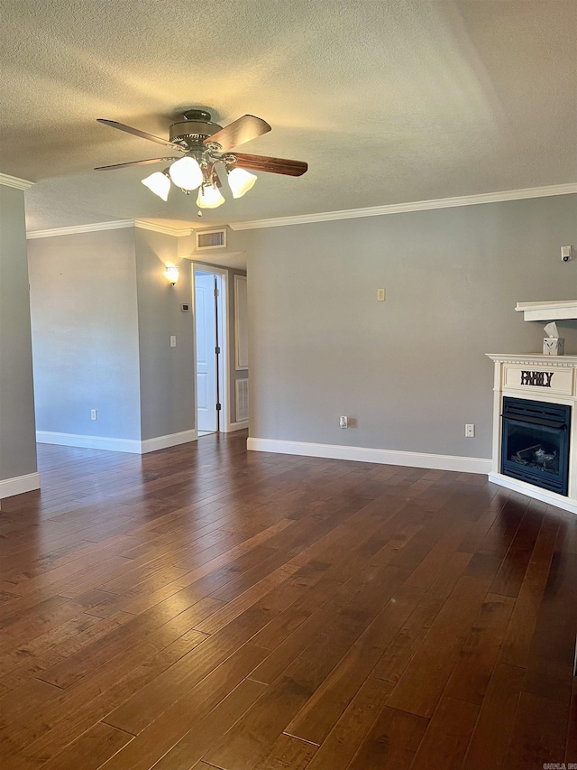 unfurnished living room featuring dark wood finished floors, visible vents, crown molding, and ceiling fan