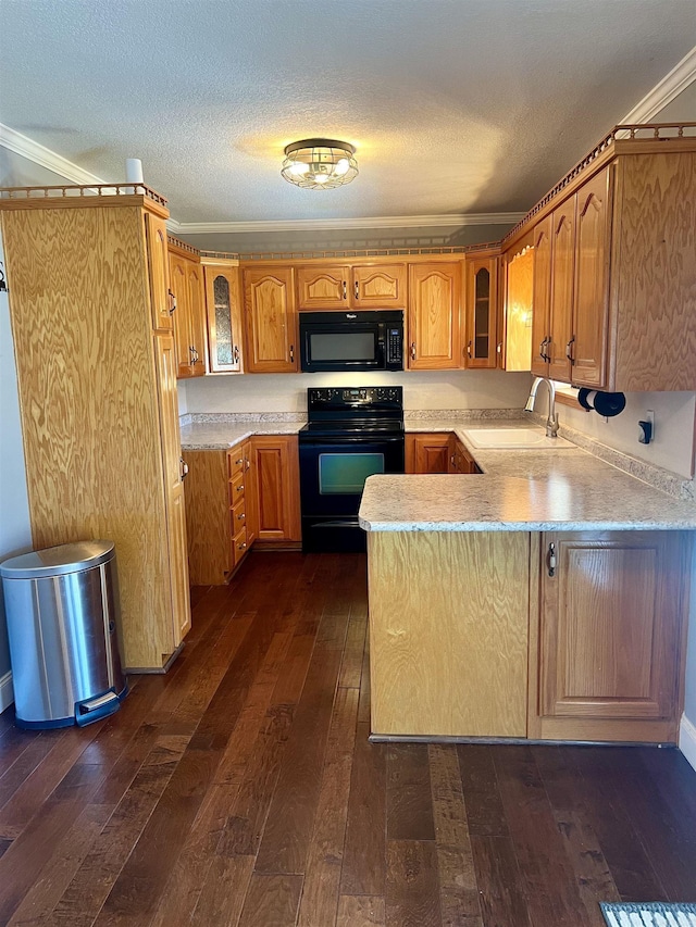 kitchen with dark wood-style flooring, black appliances, glass insert cabinets, and a sink