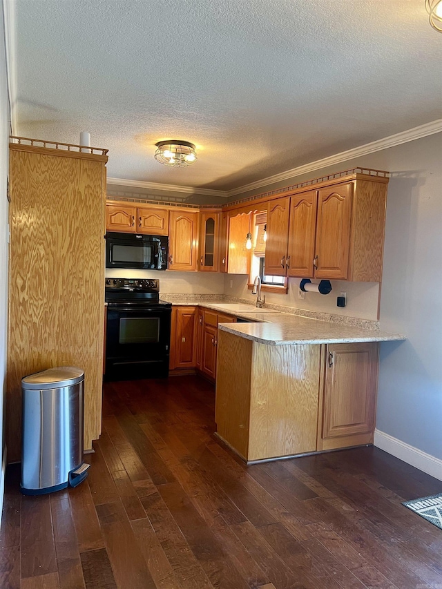 kitchen featuring dark wood-style floors, a peninsula, black appliances, light countertops, and crown molding