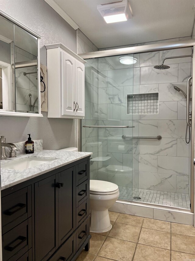 full bath featuring vanity, a stall shower, crown molding, toilet, and a textured wall