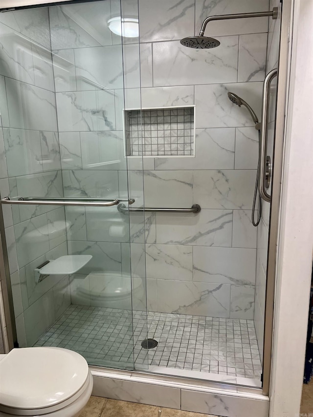 bathroom featuring a shower stall and toilet