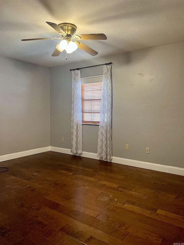 unfurnished room with ceiling fan, baseboards, a textured ceiling, and dark wood finished floors