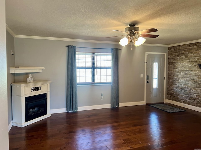 unfurnished living room featuring hardwood / wood-style floors, a glass covered fireplace, and a textured ceiling