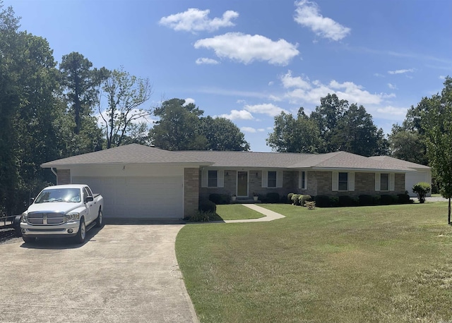 ranch-style house with a front yard, concrete driveway, and an attached garage