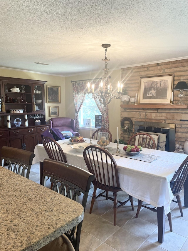 dining room featuring an inviting chandelier, light tile patterned floors, visible vents, and a textured ceiling