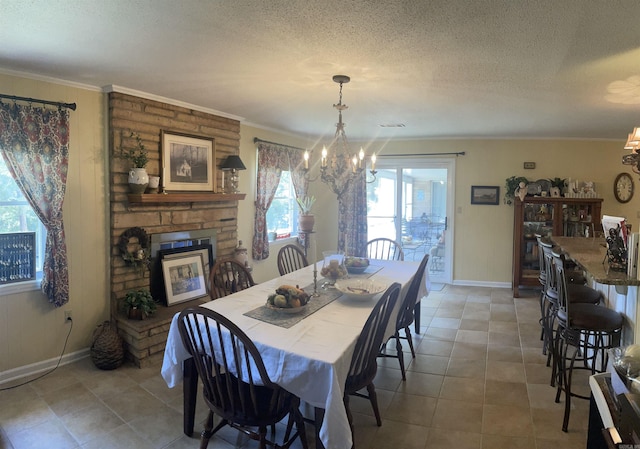 dining space with visible vents, baseboards, an inviting chandelier, ornamental molding, and a textured ceiling