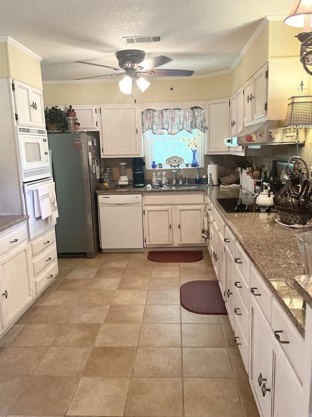 kitchen with visible vents, white appliances, crown molding, and a sink