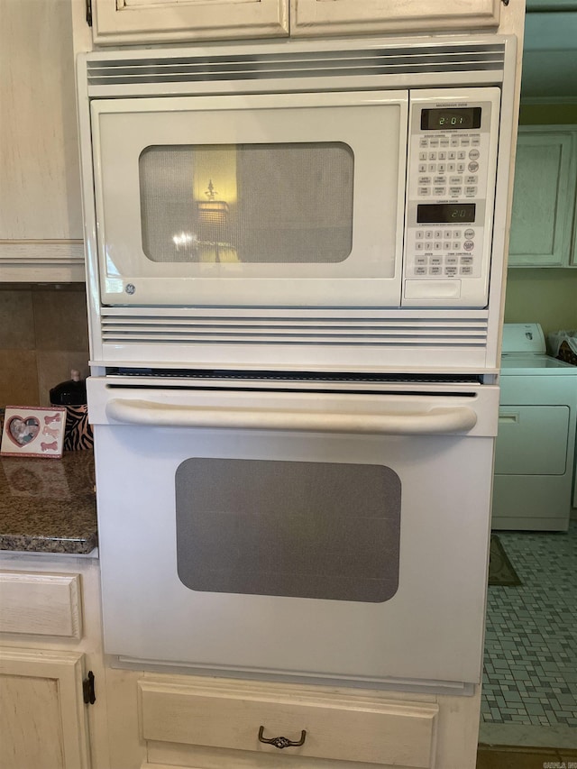 room details featuring white appliances and washing machine and dryer