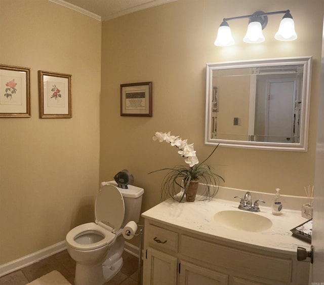 half bathroom with tile patterned flooring, crown molding, baseboards, toilet, and vanity