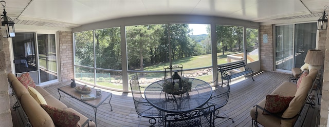 sunroom with lofted ceiling and a healthy amount of sunlight