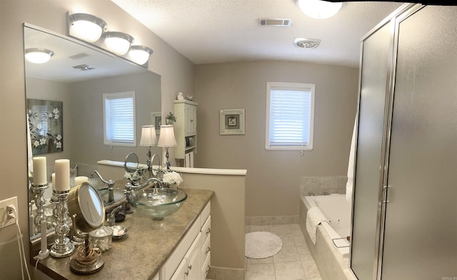 bathroom with baseboards, a stall shower, a bath, tile patterned floors, and vanity