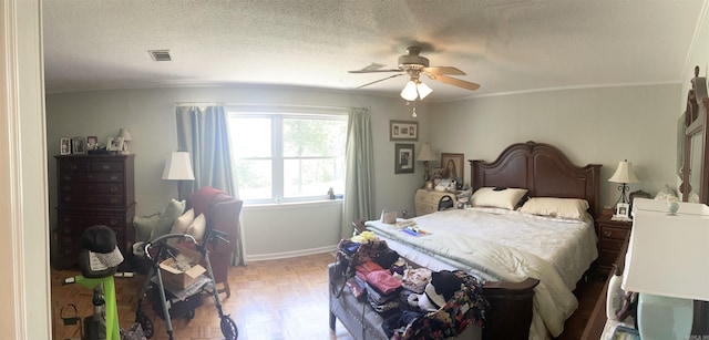 bedroom featuring a ceiling fan, baseboards, visible vents, ornamental molding, and a textured ceiling