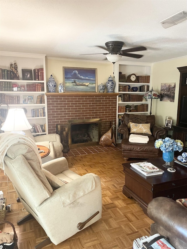 living area with visible vents, a textured ceiling, a fireplace, and crown molding