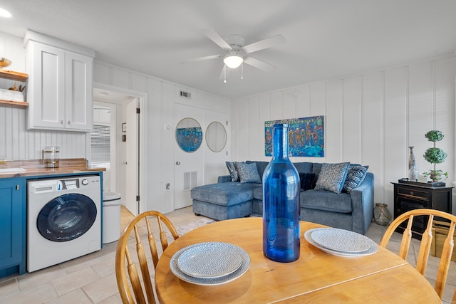 dining room featuring washer / dryer, a ceiling fan, and visible vents