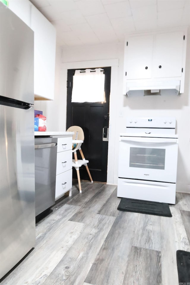 kitchen featuring appliances with stainless steel finishes, white cabinetry, light countertops, and light wood-style floors