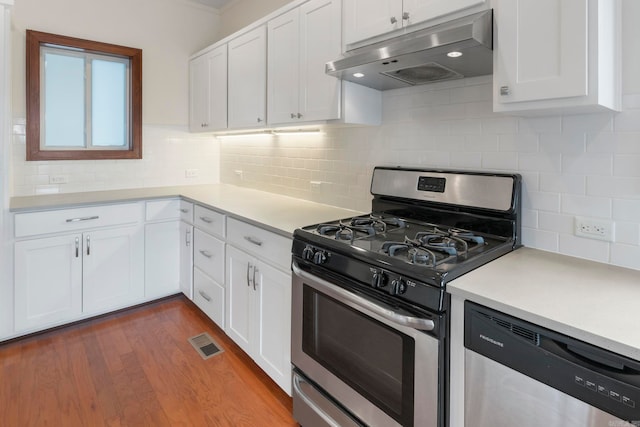 kitchen featuring under cabinet range hood, visible vents, appliances with stainless steel finishes, and white cabinetry