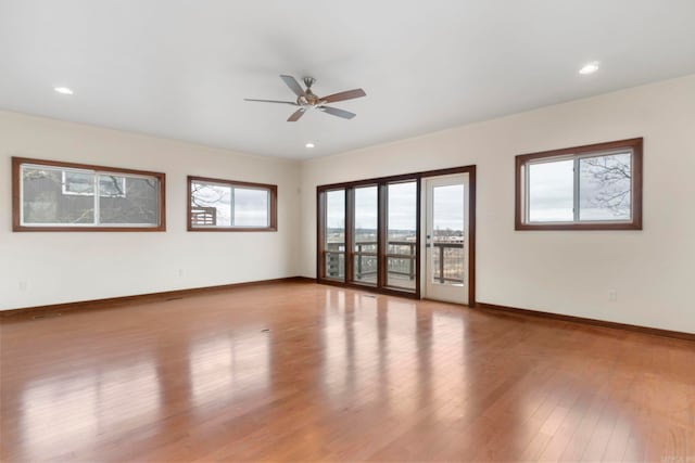 spare room with recessed lighting, wood finished floors, baseboards, and ceiling fan