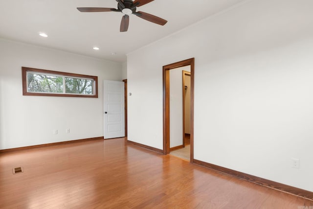 spare room featuring visible vents, a ceiling fan, wood finished floors, recessed lighting, and baseboards