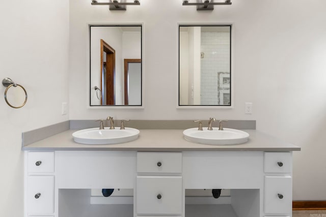 full bathroom with a sink and double vanity