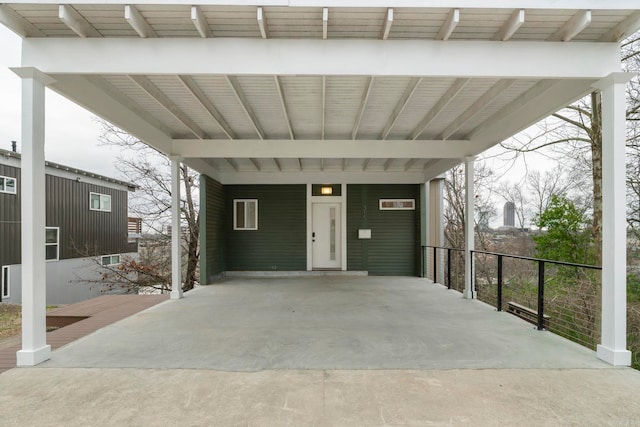 view of patio featuring a carport and fence