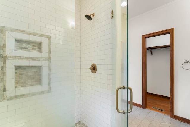 full bathroom with crown molding, baseboards, visible vents, and a stall shower