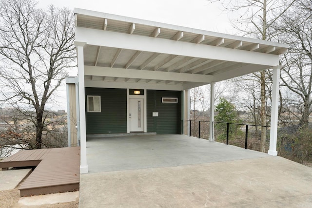 view of patio / terrace with an attached carport and driveway