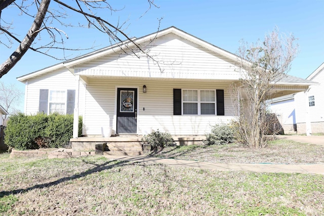 bungalow-style home with a carport and a porch