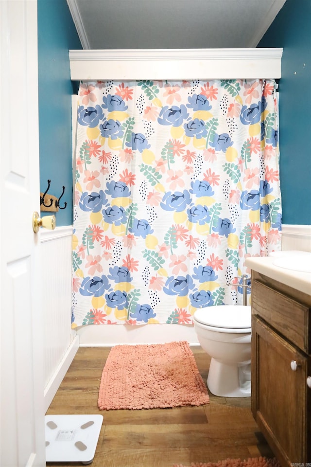 full bath featuring toilet, curtained shower, wood finished floors, crown molding, and vanity