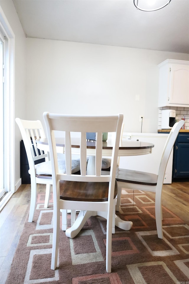 dining room with plenty of natural light and light wood finished floors