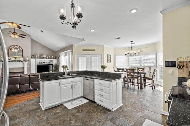 kitchen featuring visible vents, open floor plan, stainless steel dishwasher, white cabinetry, and a sink